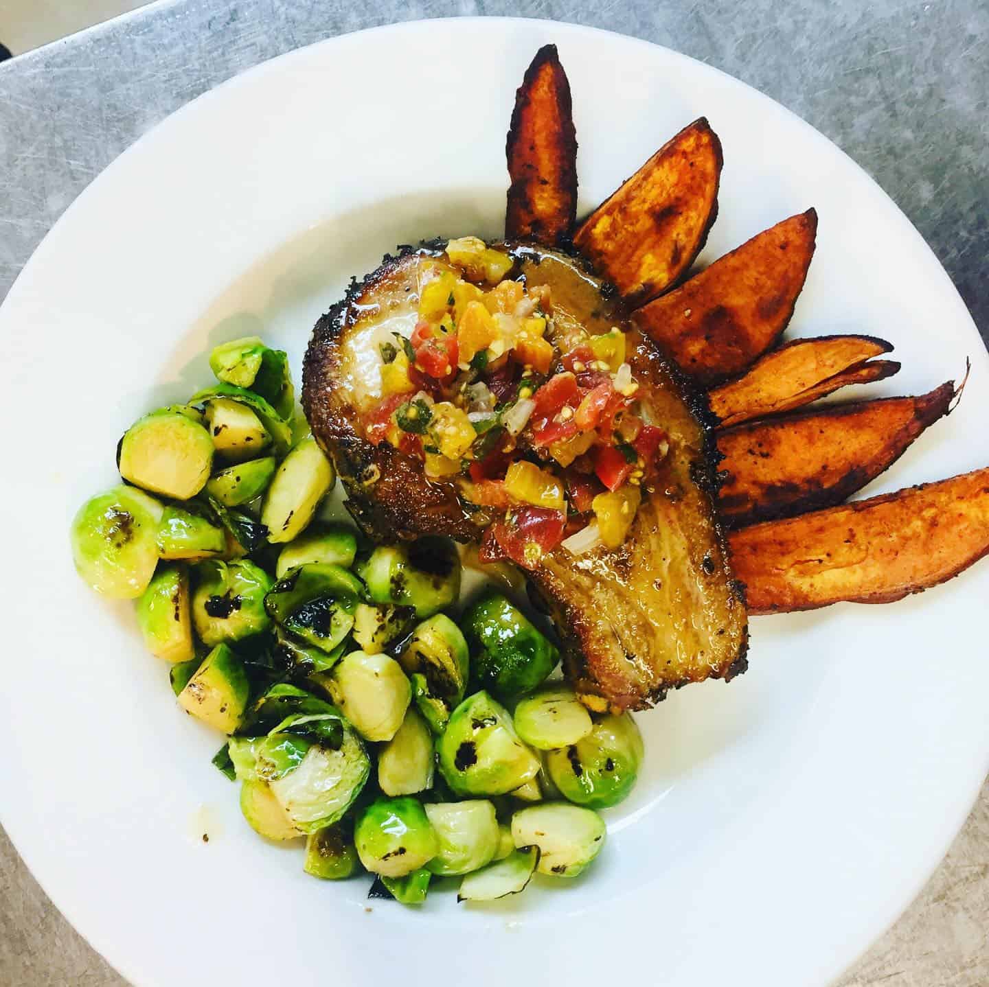 Our recent pork chop special, with sweet potato wedges, brussel sprouts and bruschetta. Keep up with us on social media for our daily specials, but most meals can be altered to meet your dietary needs.
