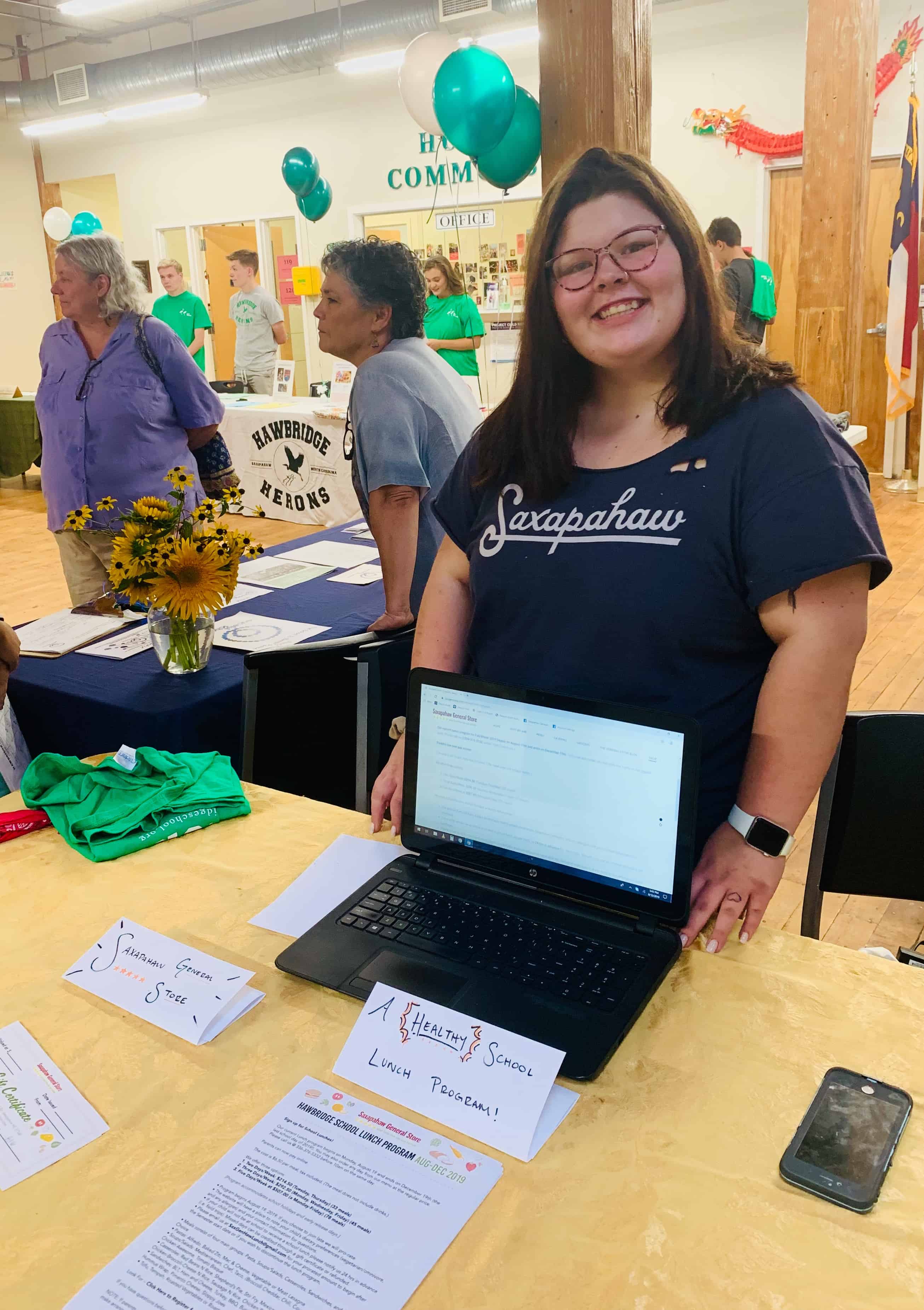 Amber, a former Hawbridge student, at this year's open house, ready to inform parents and students about the General Store's school lunch program